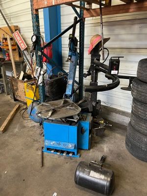 a machine that is sitting in a garage with a tire