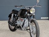 a motorcycle that is parked in front of a garage door