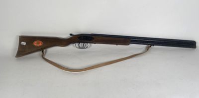 a rifle that is on a white surface with a brown handle