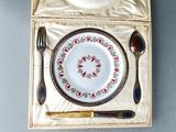 a plate and fork in a box with a spoon and fork