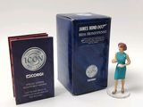 a figurine of a woman standing next to a box of books