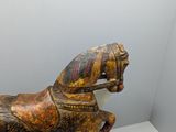 a wooden horse that is sitting on a table
