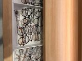 many pairs of glasses on the shelves in the room