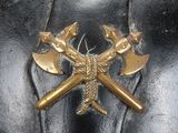 a black leather bag with two crossed axes on it