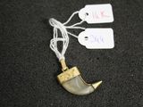 un gros plan d'un collier orné d'un objet en forme de corne
