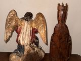 a statue of an angel sitting on top of a wooden table
