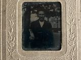 an old photo of a man in a suit and bow tie