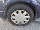 a close up of a tire on a blue car