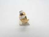 a close up of a gold and diamond ring on a white surface