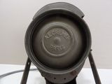 an old cast iron pot sitting on a stand