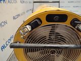 a yellow blower sitting on the floor next to a wall