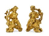 pair of antique gold figurines of a boy and a girl on a lion