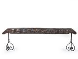 wrought iron bench with ornate scroll design on legs