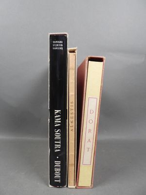 two books are stacked on top of each other on a gray surface