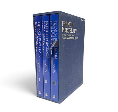 a set of three books sitting on top of each other on a white surface