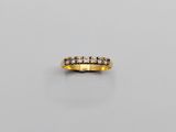 a gold and diamond band ring