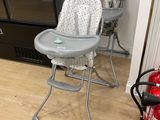 a baby high chair and a fire extinguisher in the kitchen
