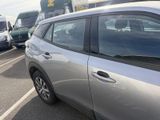 a silver car parked in a parking lot next to other cars