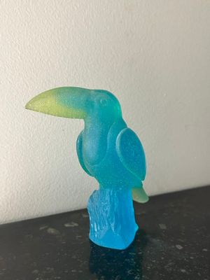 a small blue bird sitting on top of a table