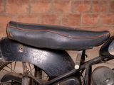 a motorcycle that is parked in front of a brick wall