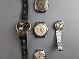 a lot of watches that are sitting on a table