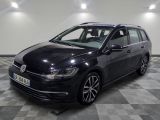 La Volkswagen Golf break noire est garée dans une grande pièce au sol carrelé.