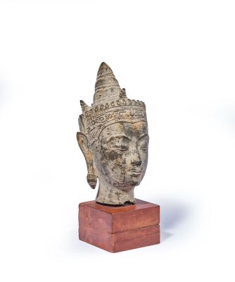 sculpture of a head on a wooden base on a white background