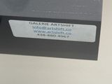 a picture of a glass shelf with a label on it