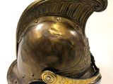 a bronze helmet on a white surface
