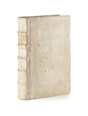an old book sitting on top of a white surface