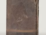 an image of a small metal object on a reflective surface