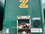 a large green box truck parked in a parking lot