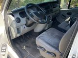 the interior of a car with the door open and the driver ' s seat down