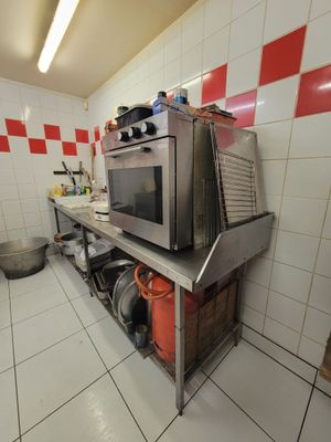 a kitchen with a stove and a microwave on the counter