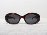 a close up of a pair of sunglasses on a white surface