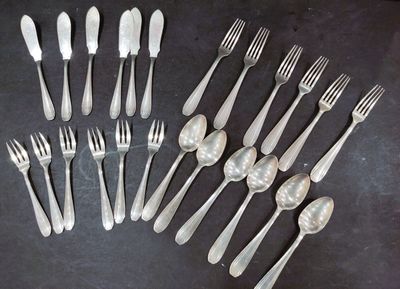 a lot of forks and spoons that are on the table