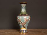 a vase that is sitting on a table with a black background