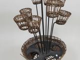 a basket with a bunch of baskets in it on a stand