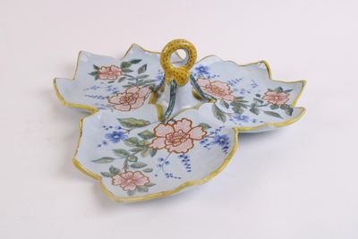 a blue and pink flowered plate with a gold ring on it