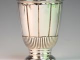a silver vase that is sitting on a table