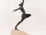 bronze statue of a woman holding a spear on a wooden base