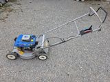 a small lawn mower that is sitting on the ground