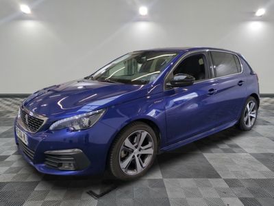 a blue car is parked in a room with a checkered floor