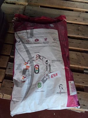 a bag of food sitting on a pallet on the floor