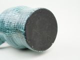 a close up of a blue and white vase