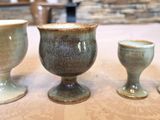 three cups sitting on a table next to each other