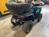 a black atv with a box on the back of it