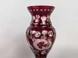a red vase that is sitting on a table