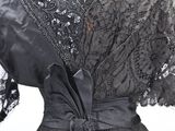 an image of a woman ' s black dress with a bow on the waist