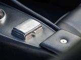 a close up of a car dashboard with a metal button